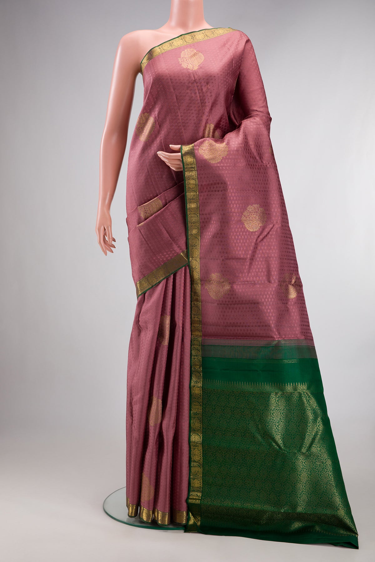 Pure Silk Peach Kanjivaram Saree with Jacquard With Zari Butta on the body and Zari Border.  displayed on a mannequin