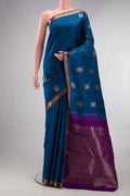 Pure Silk Peacock Blue Kanjivaram Saree with Jacquard With Zari Butta on the body and Zari Border.  displayed on a mannequin