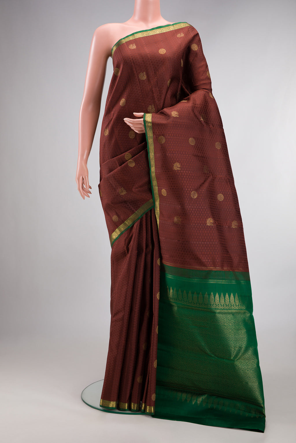 Pure Silk Brown Kanjivaram Saree with Jacquard With Zari Butta on the body and Zari Border.  displayed on a mannequin