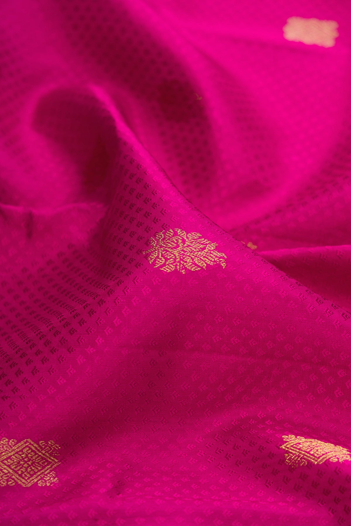 Close up of Pure Silk Pink Kanjivaram Saree with Jacquard With Zari Butta on the body and Zari Border.  displaying folds