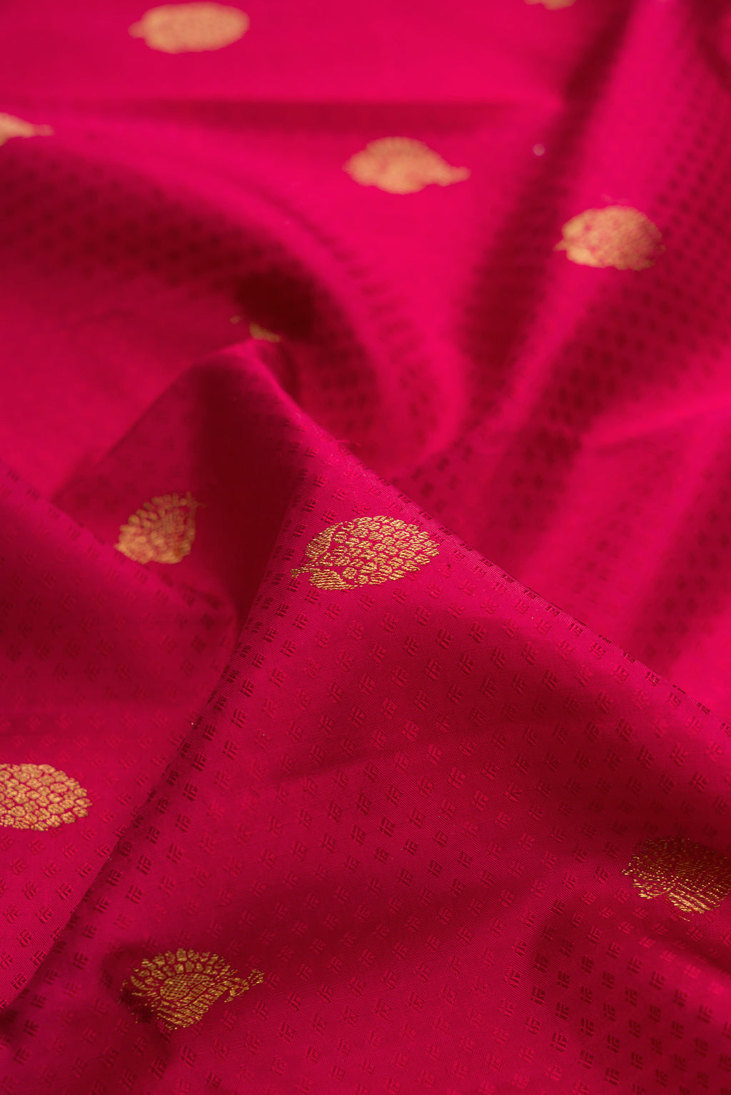 Close up of Pure Silk Red Kanjivaram Saree with Jacquard With Zari Butta on the body and Zari Border.  displaying folds