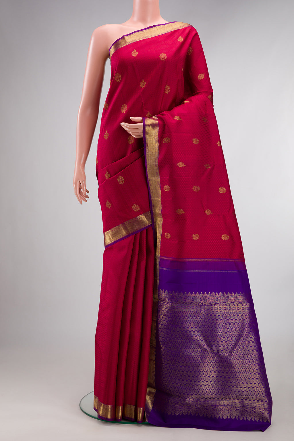 Pure Silk Red Kanjivaram Saree with Jacquard With Zari Butta on the body and Zari Border.  displayed on a mannequin
