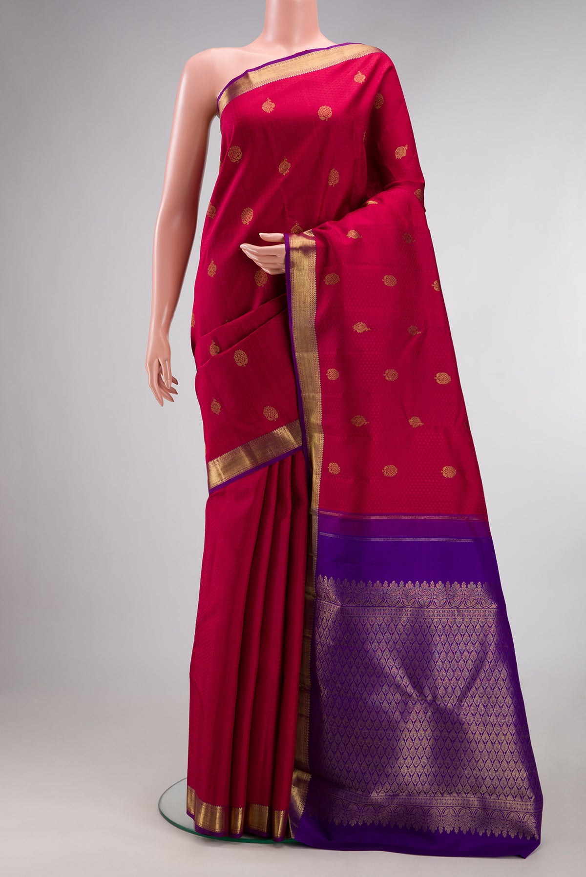 Pure Silk Red Kanjivaram Saree with Jacquard With Zari Butta on the body and Zari Border.  displayed on a mannequin