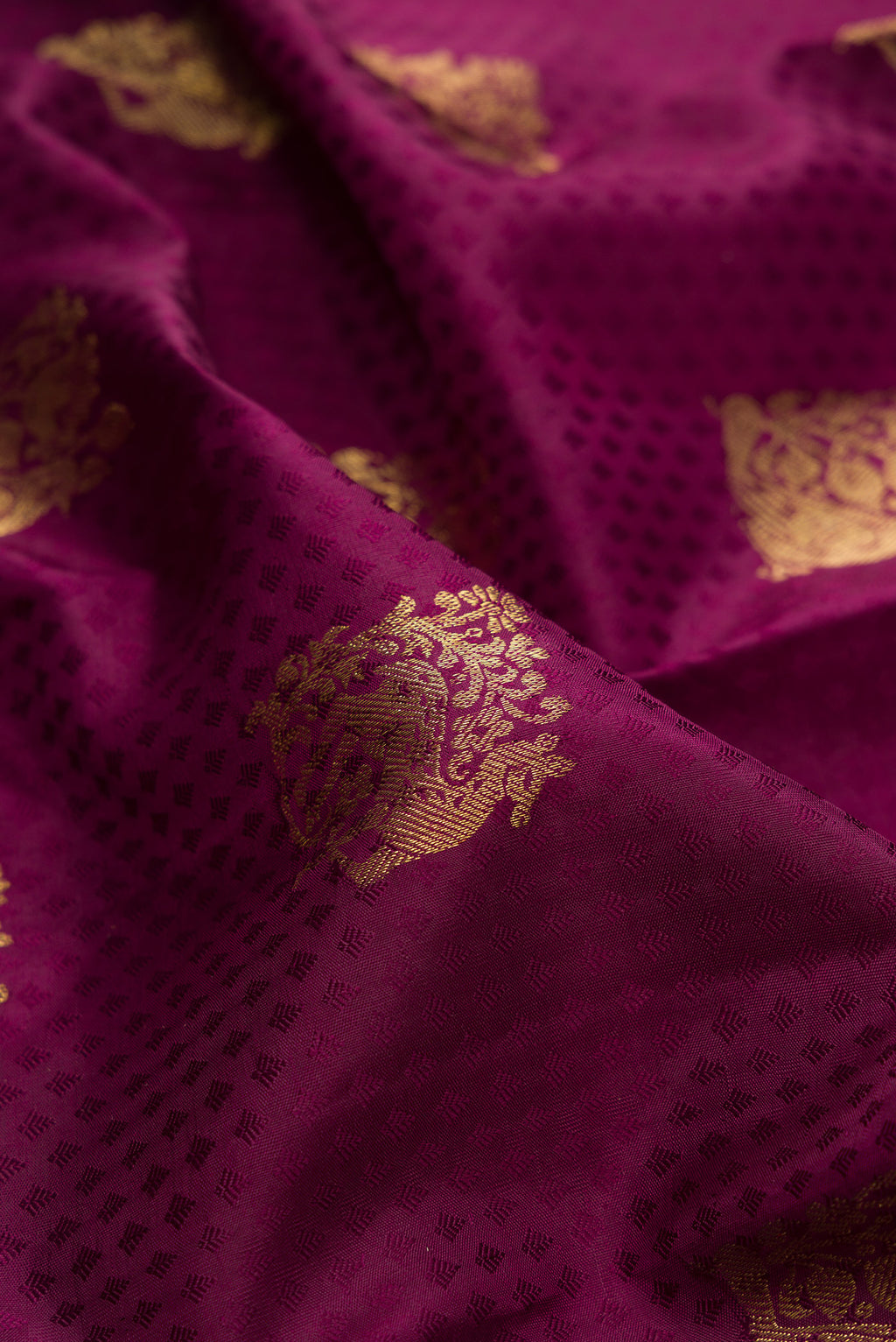 Close up of Pure Silk Maroon Kanjivaram Saree with Jacquard With Zari Butta on the body and Zari Border.  displaying folds