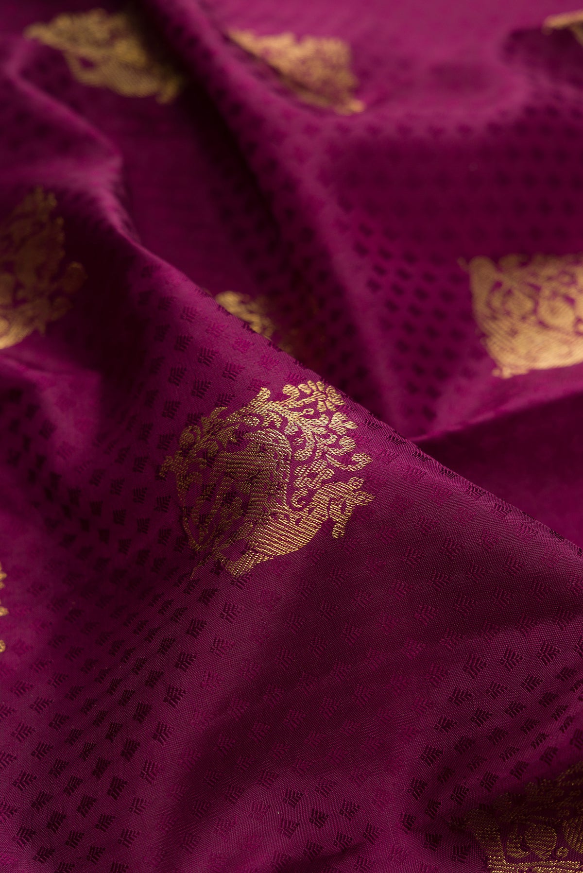 Close up of Pure Silk Maroon Kanjivaram Saree with Jacquard With Zari Butta on the body and Zari Border.  displaying folds