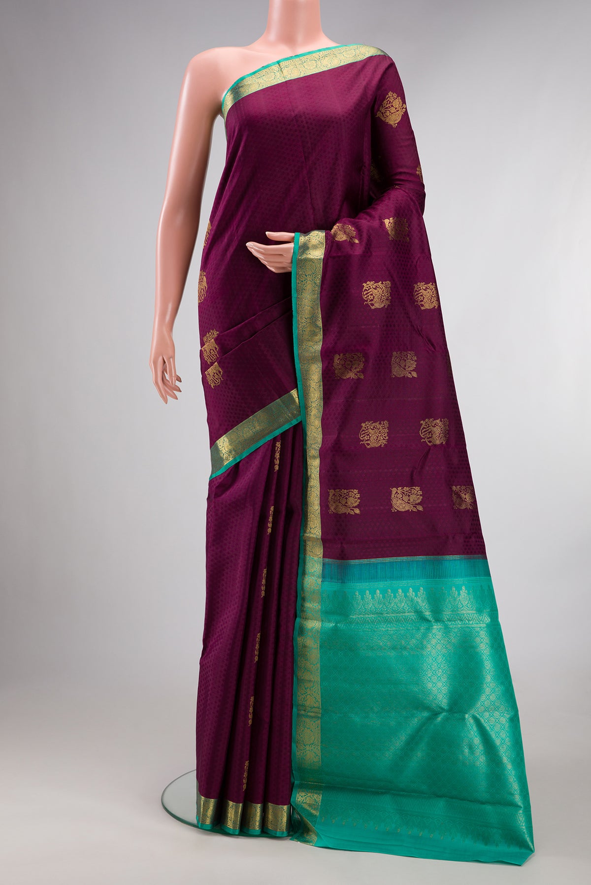 Pure Silk Maroon Kanjivaram Saree with Jacquard With Zari Butta on the body and Zari Border.  displayed on a mannequin