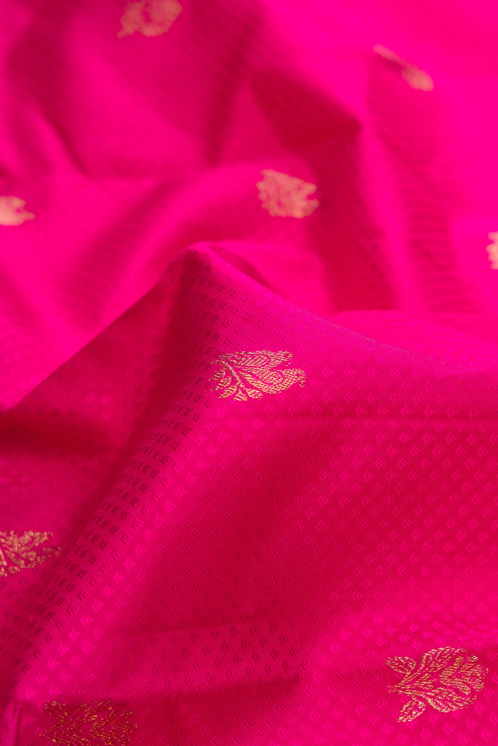 Close up of Pure Silk Pink Kanchipuram Saree with Jacquard With Zari Butta on the body and Zari Border.  displaying folds