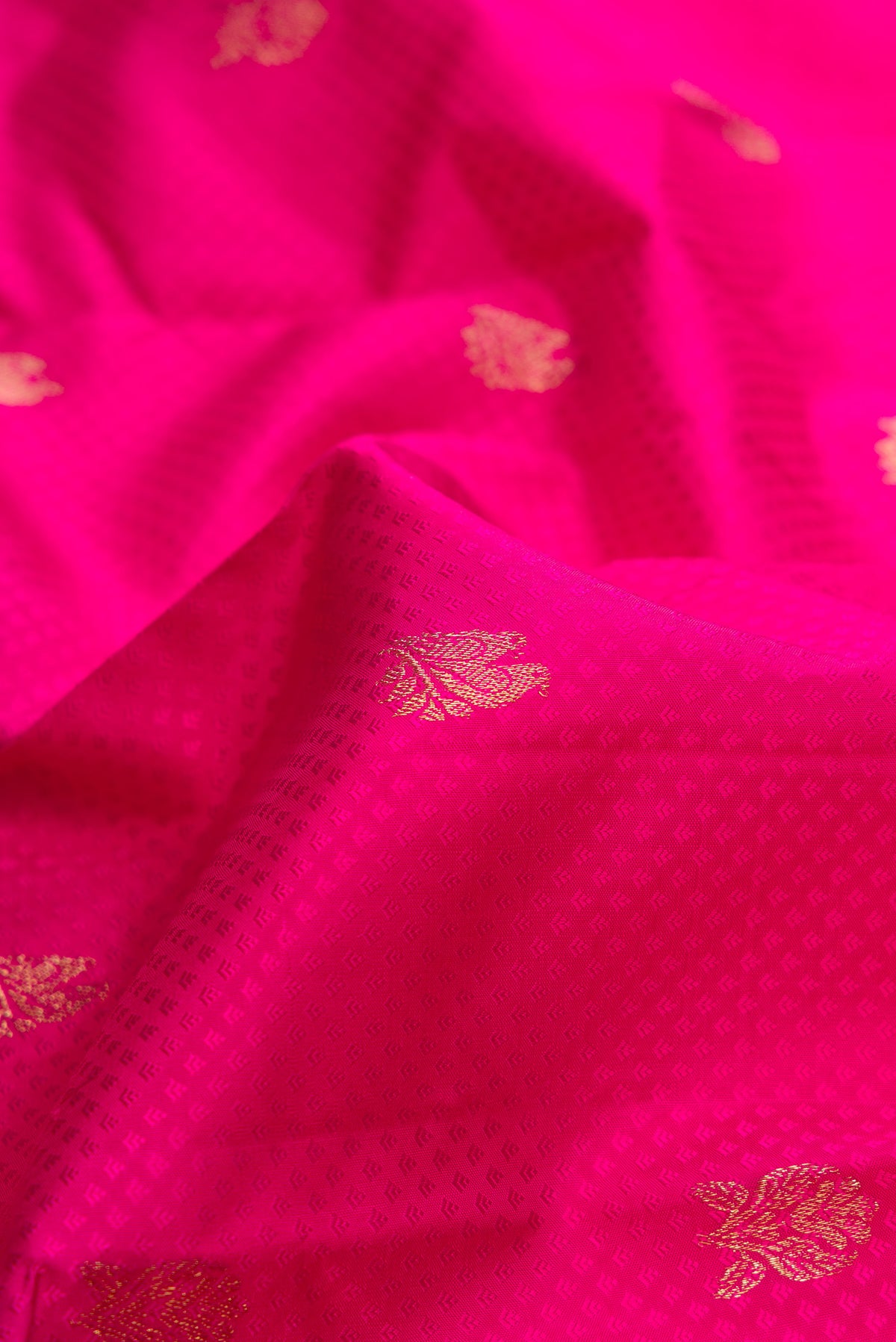 Close up of Pure Silk Pink Kanchipuram Saree with Jacquard With Zari Butta on the body and Zari Border.  displaying folds