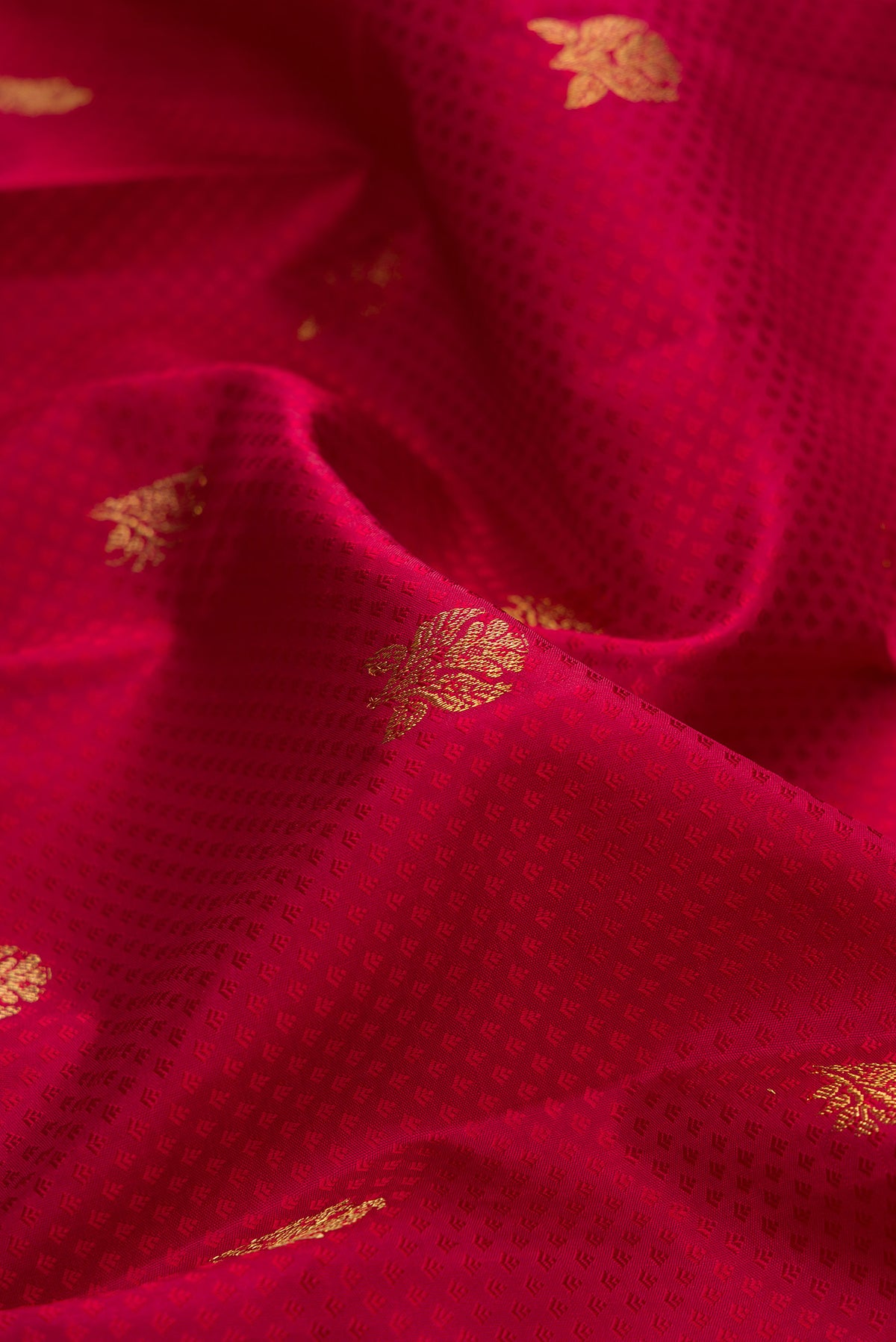 Close up of Pure Silk Deep Red Kanchipuram Saree with Jacquard With Zari Butta on the body and Zari Border.  displaying folds