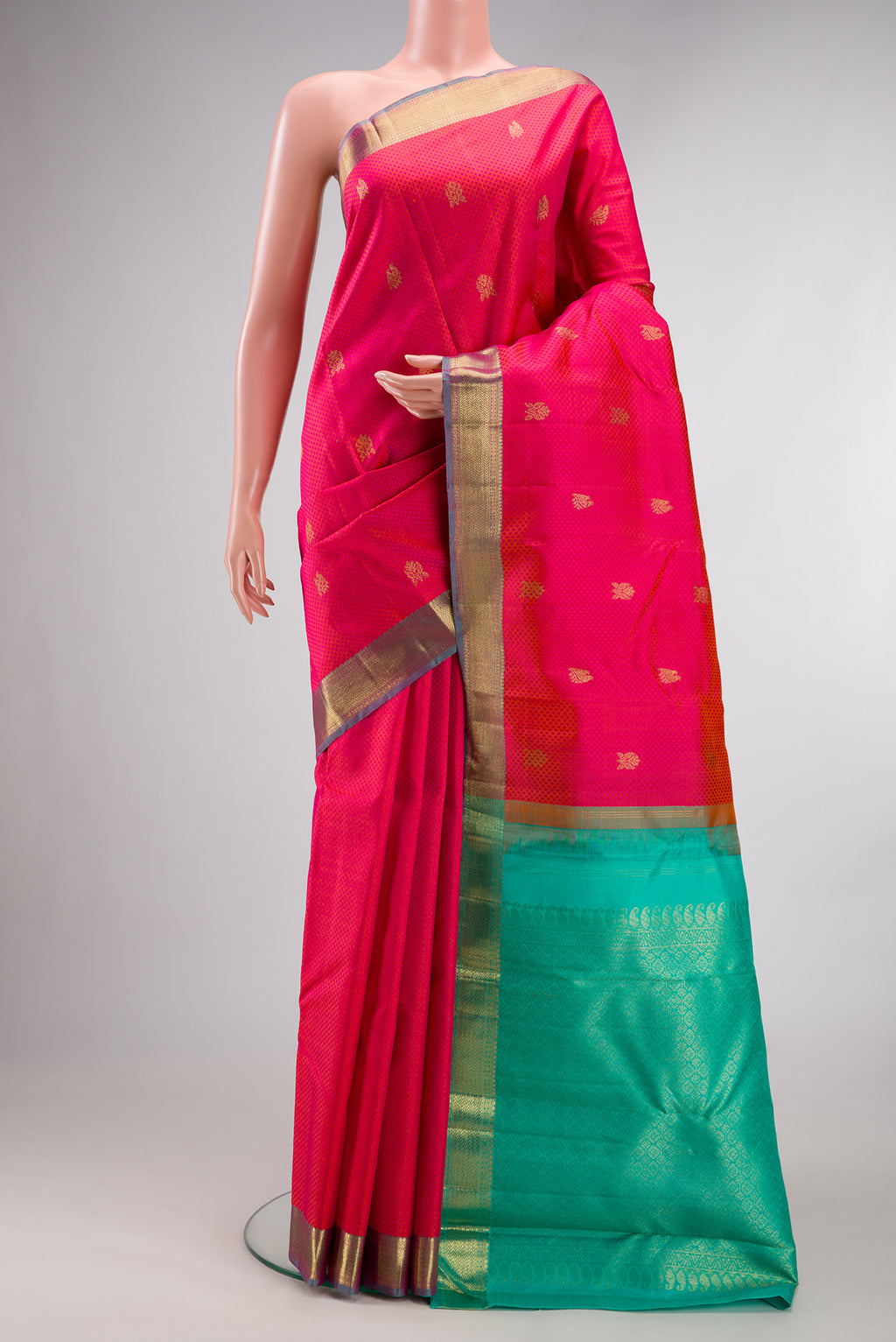 Pure Silk Coral Kanchipuram Saree with Jacquard With Zari Butta on the body and Zari Border.  displayed on a mannequin