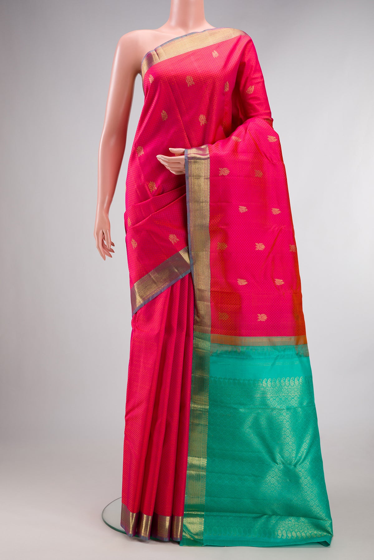 Pure Silk Coral Kanchipuram Saree with Jacquard With Zari Butta on the body and Zari Border.  displayed on a mannequin
