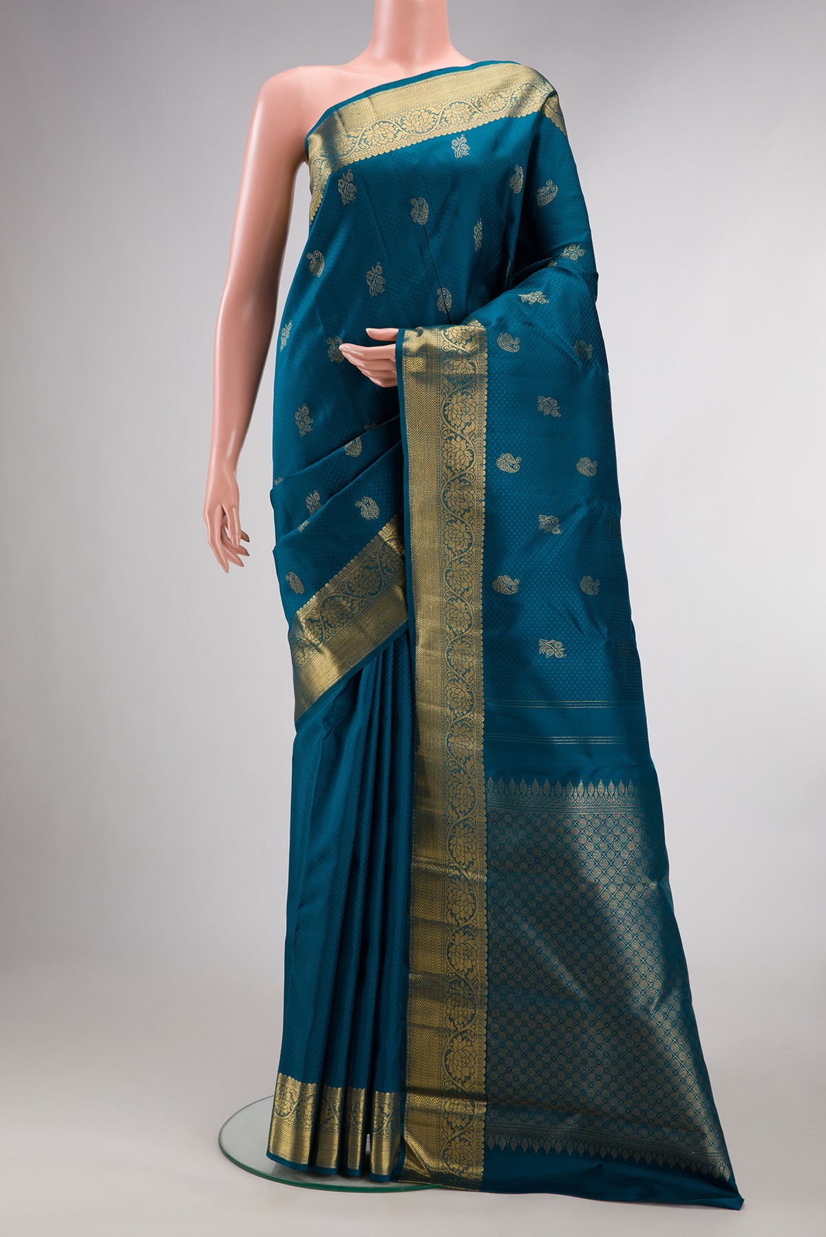 Pure Silk Pure Zari Peacock Blue Dual Tone Kanchipuram Saree with Jacquard With Zari Butta on the body and Zari Border.  displayed on a mannequin