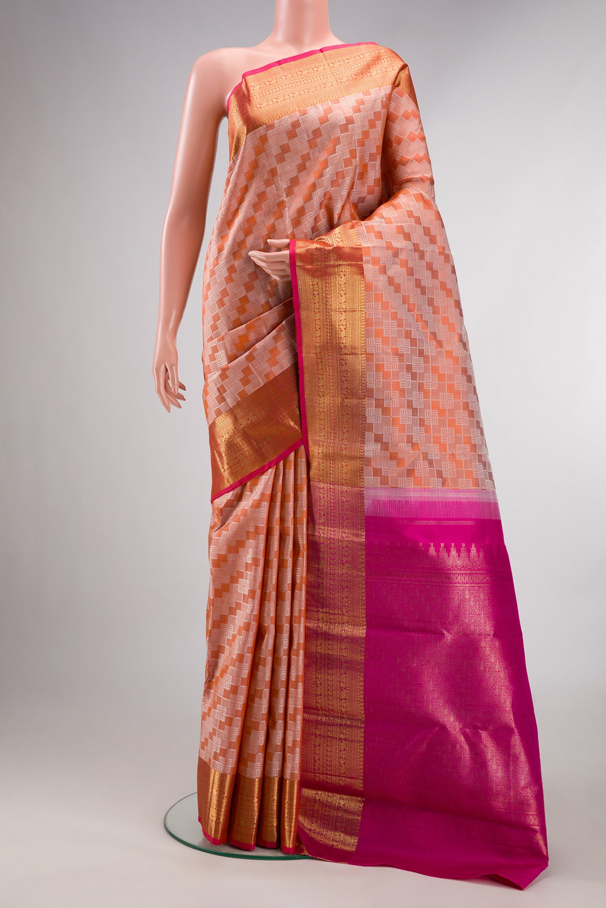 Pure Silk Pure Zari Orange Kanchipuram Saree with Jacquard design on the body and Zari Border.  displayed on a mannequin