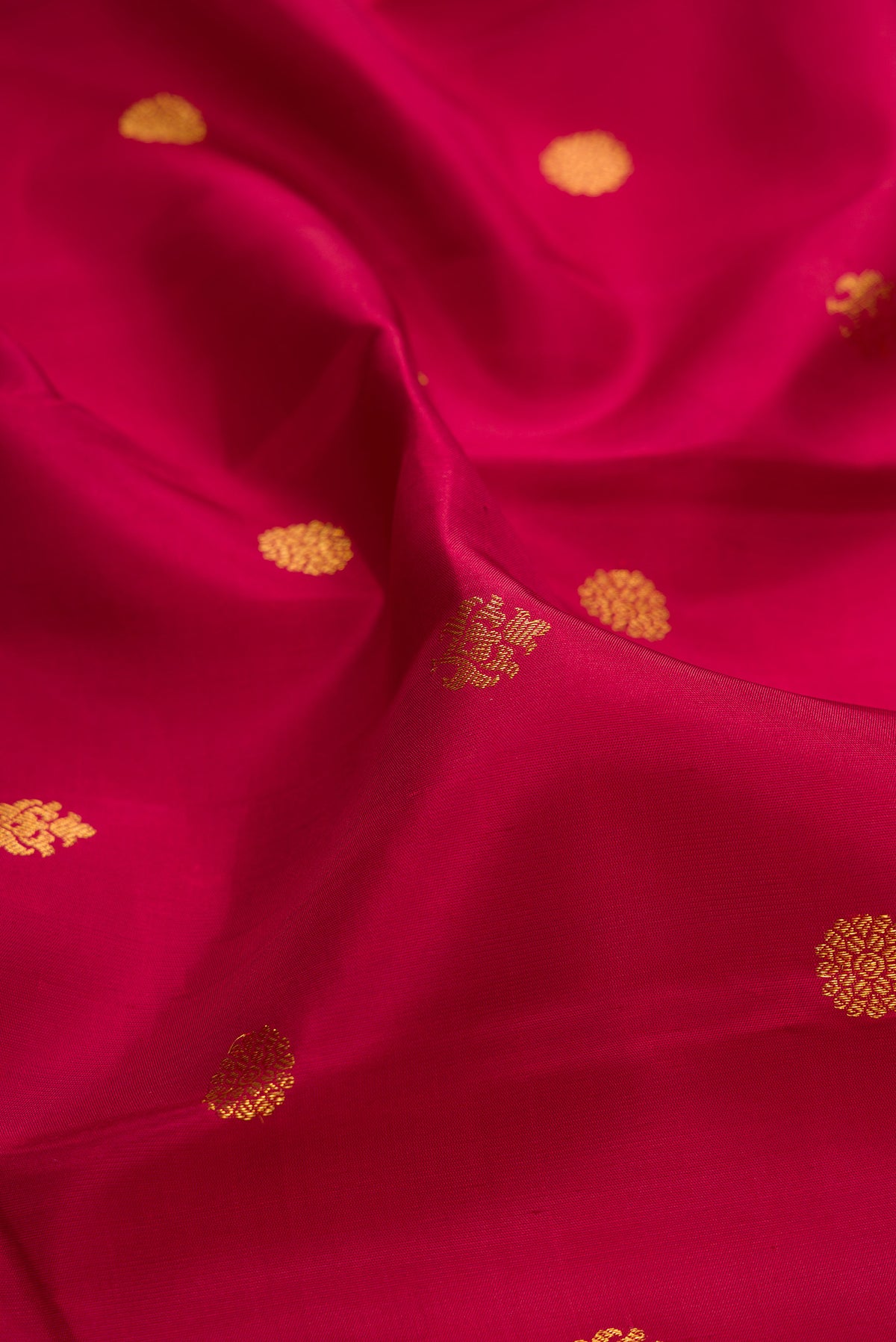 Close up of Pure Silk Maroon Kanjivaram Saree with Zari Butta on the body and Fancy Border.  displaying folds