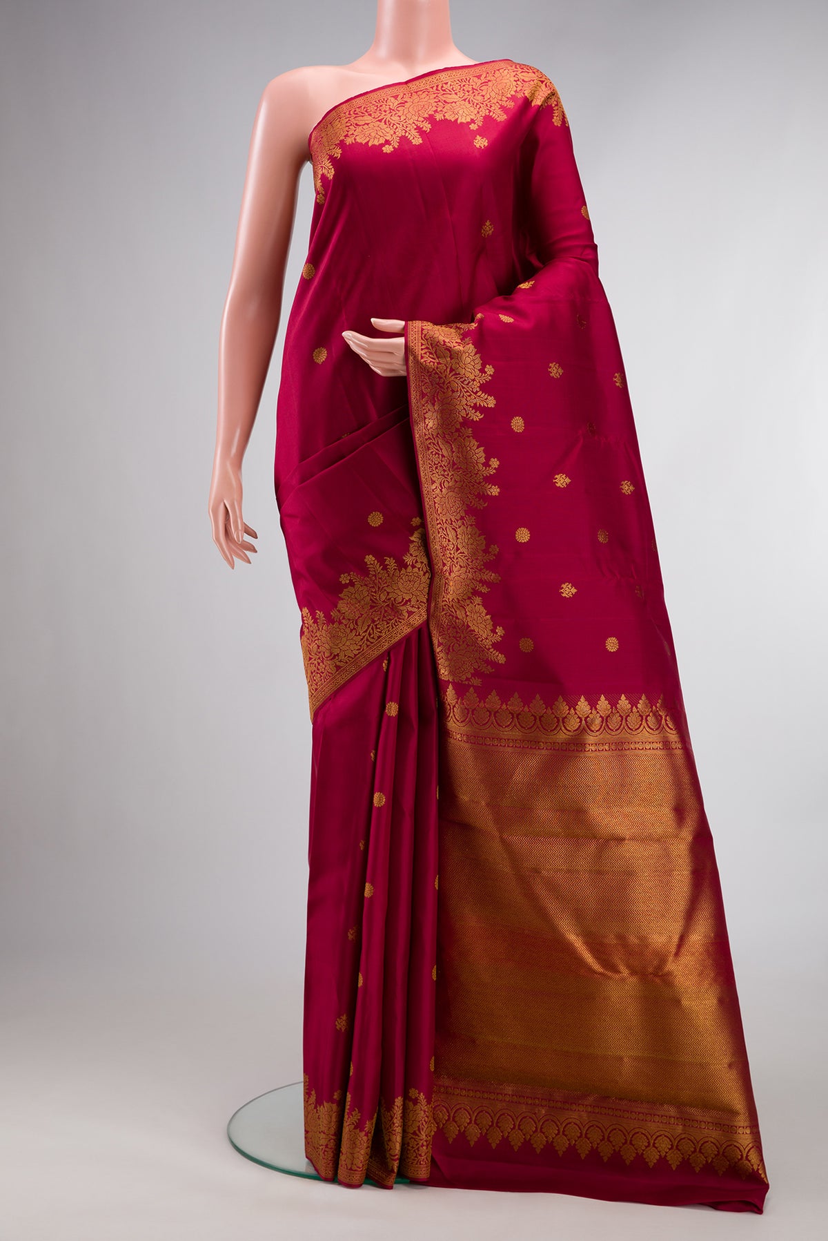 Pure Silk Maroon Kanjivaram Saree with Zari Butta on the body and Fancy Border.  displayed on a mannequin