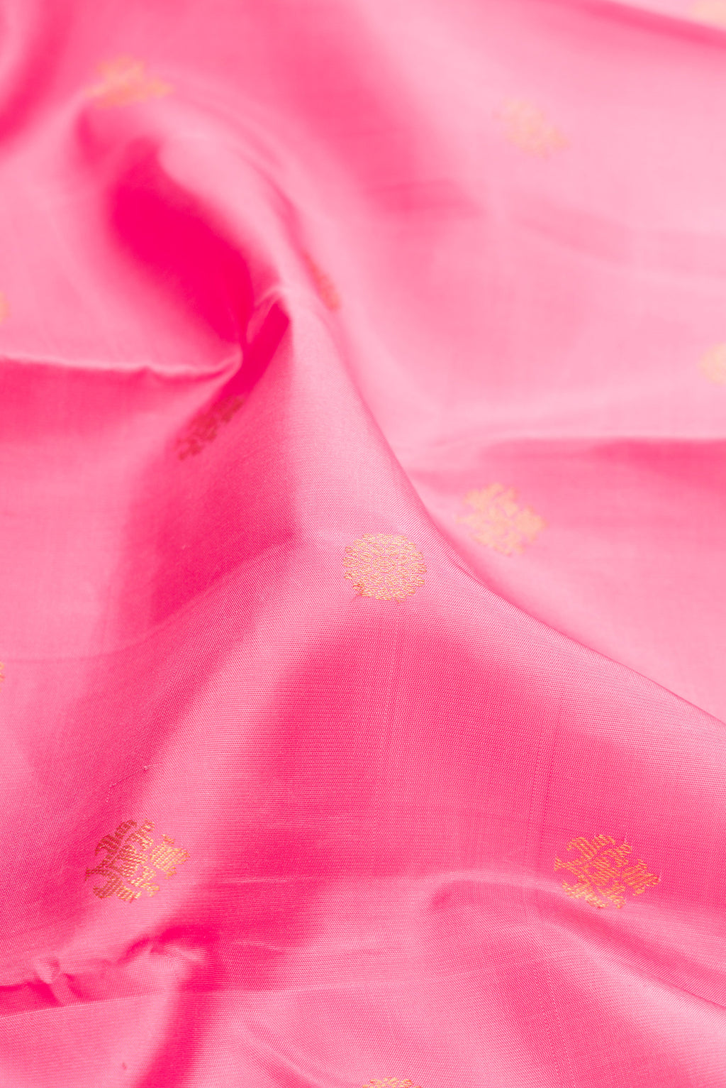 Close up of Pure Silk Pink Kanjivaram Saree with Zari Butta on the body and Fancy Border.  displaying folds