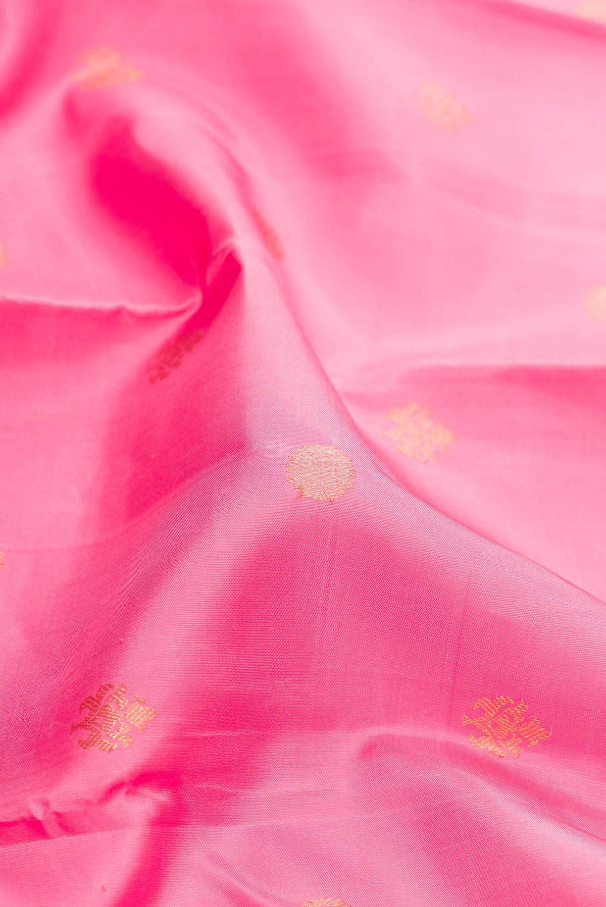 Close up of Pure Silk Pink Kanjivaram Saree with Zari Butta on the body and Fancy Border.  displaying folds