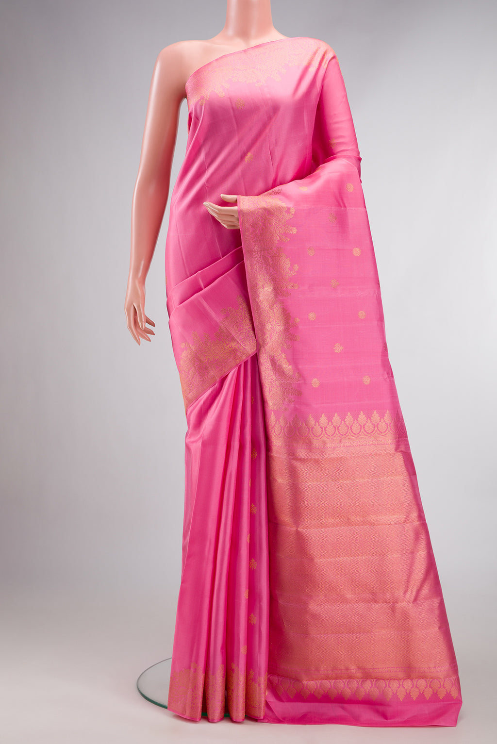 Pure Silk Pink Kanjivaram Saree with Zari Butta on the body and Fancy Border.  displayed on a mannequin
