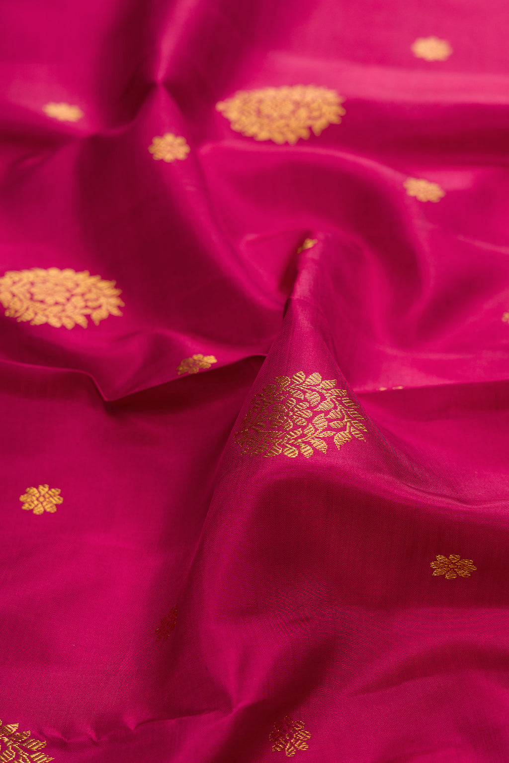 Close up of Pure Silk Maroon Kanjivaram Saree with Zari Butta on the body and Zari Border.  displaying folds