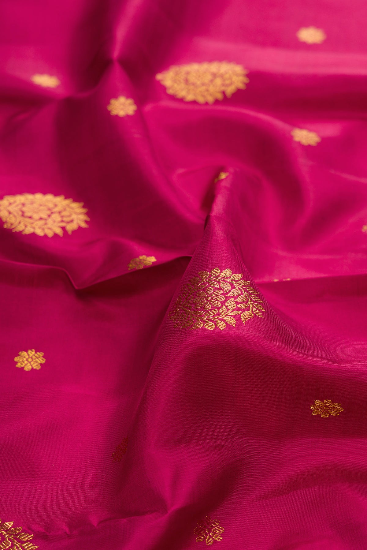 Close up of Pure Silk Maroon Kanjivaram Saree with Zari Butta on the body and Zari Border.  displaying folds