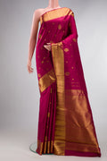 Pure Silk Maroon Kanjivaram Saree with Zari Butta on the body and Zari Border.  displayed on a mannequin