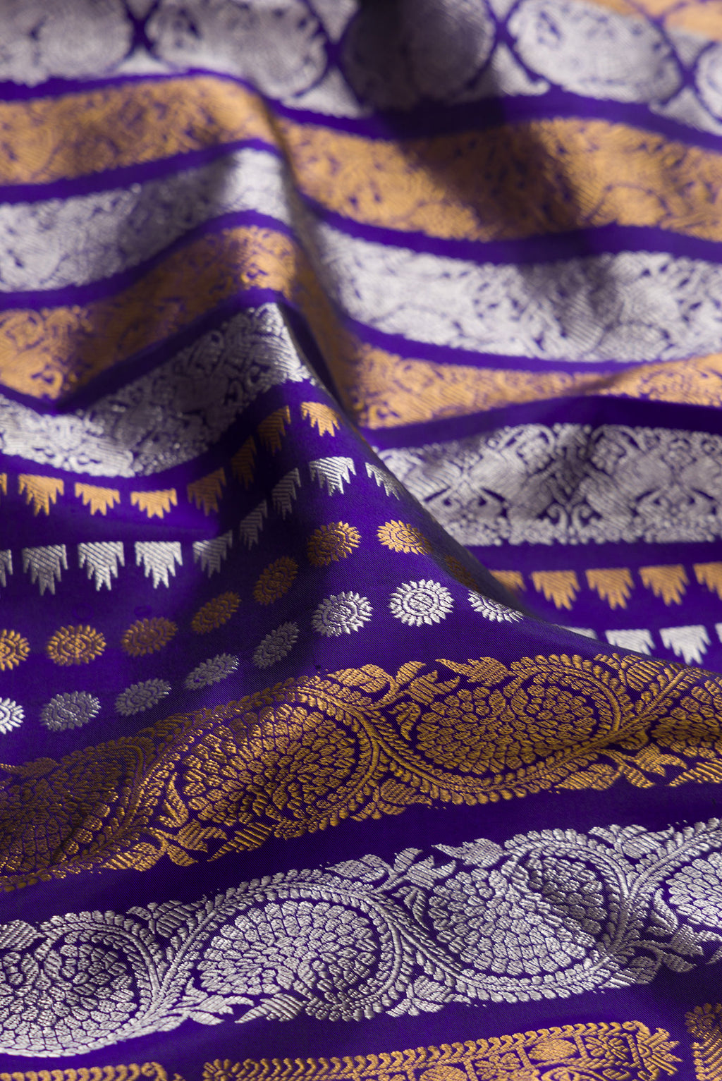 Close up of Pure Silk Dark Blue Kanjivaram Saree with Zari Butta on the body and Plain Border.  displaying folds