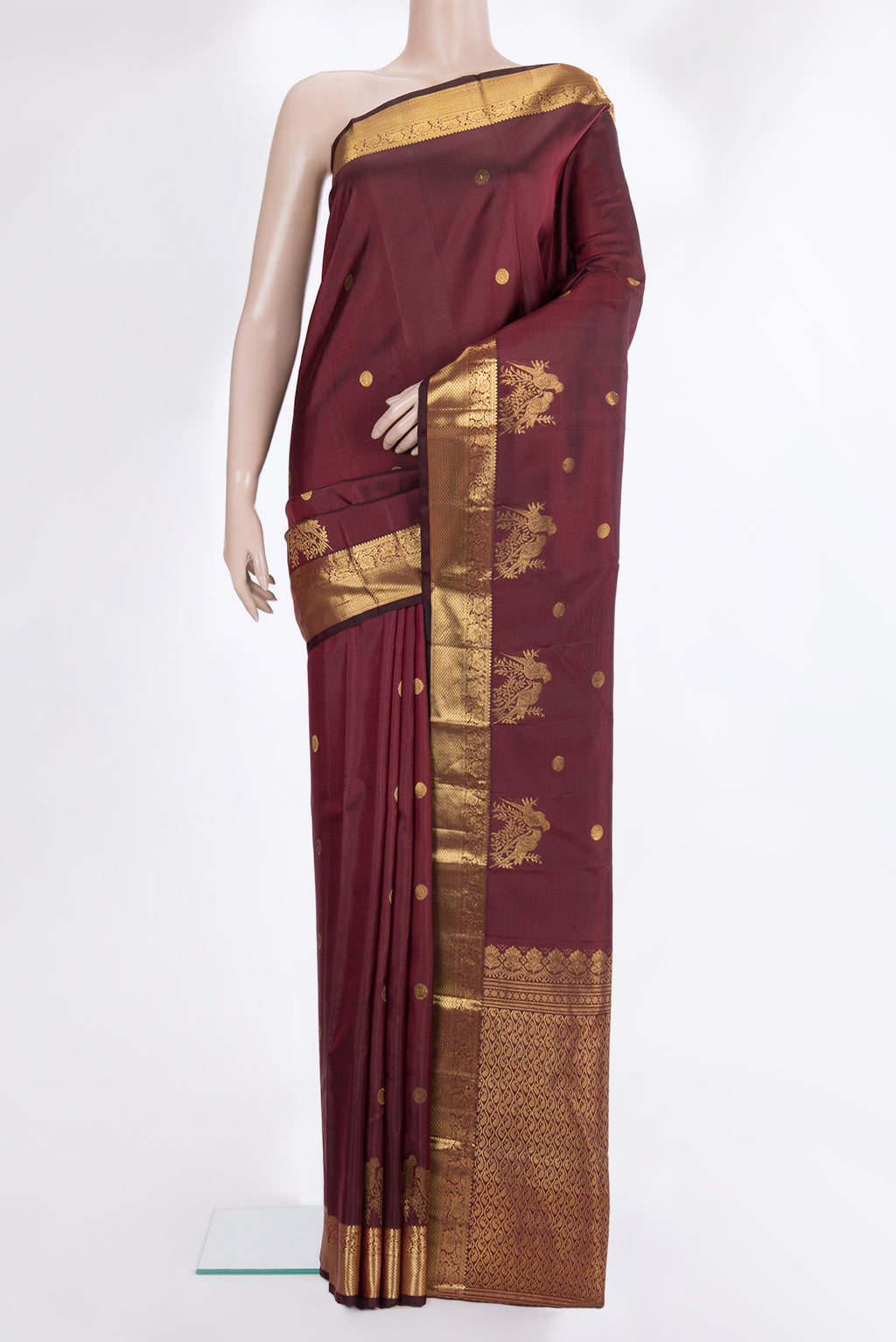 Pure Silk Maroon Kanjivaram Saree with Zari Butta on the body and Zari Border.  displayed on a mannequin