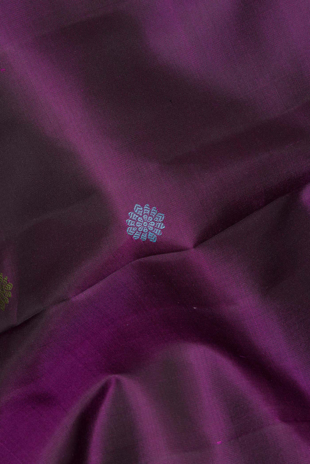 Close up of Pure Silk Purple Kanchipuram Saree with Thread Butta on the body and Zari Border.  displaying folds