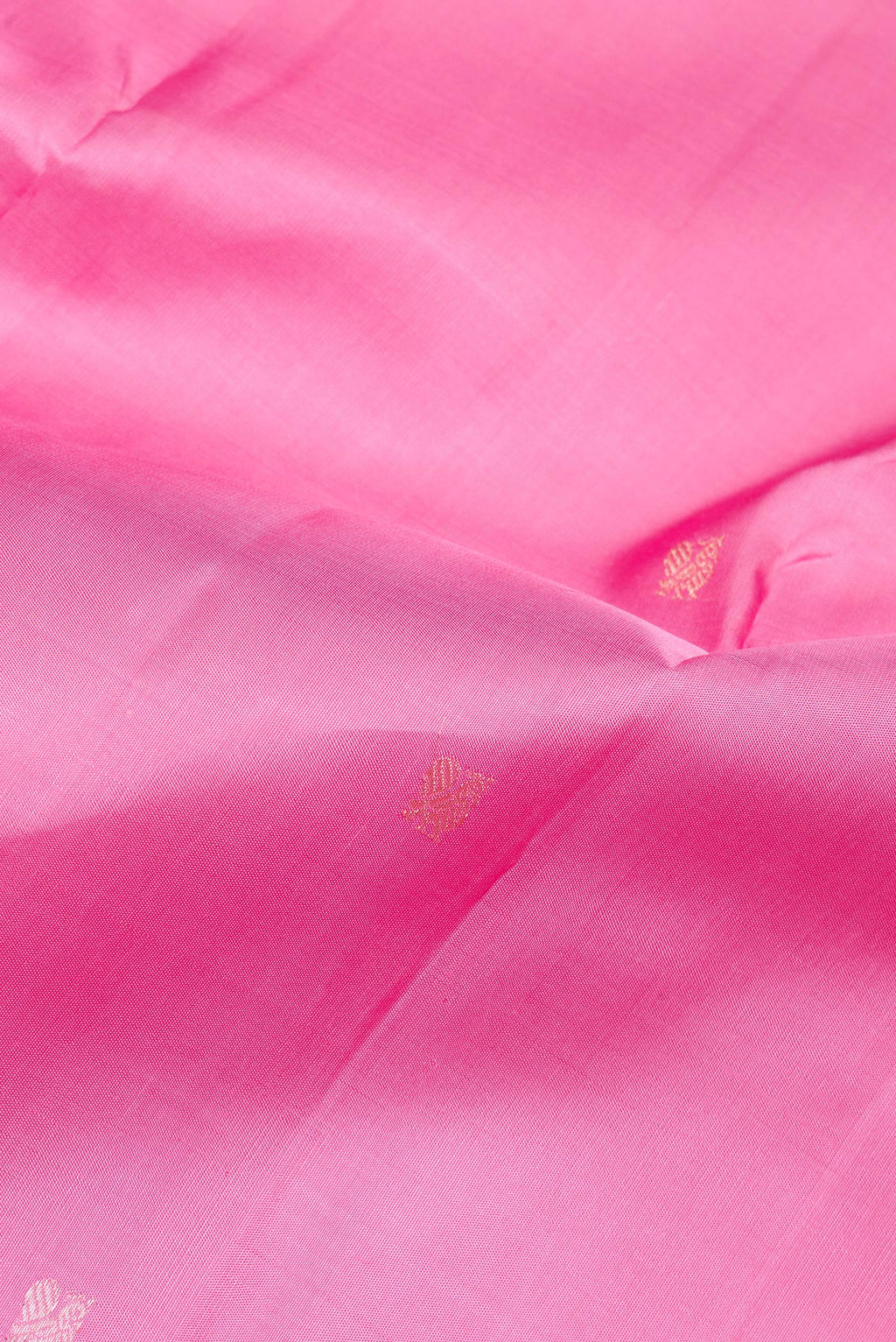 Close up of Pure Silk Rose pink Kanchipuram Saree with Zari Butta on the body and Zari Border.  displaying folds