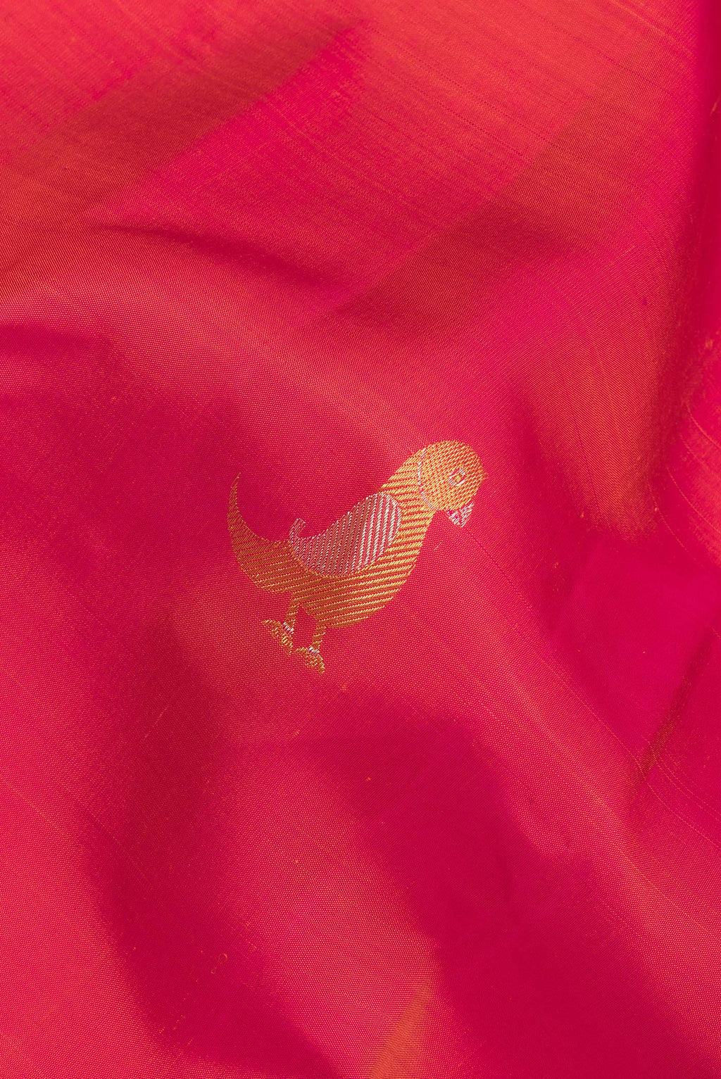 Close up of Pure Silk Red Dual Tone Kanchipuram Saree with Zari Butta on the body and Without Border.  displaying folds