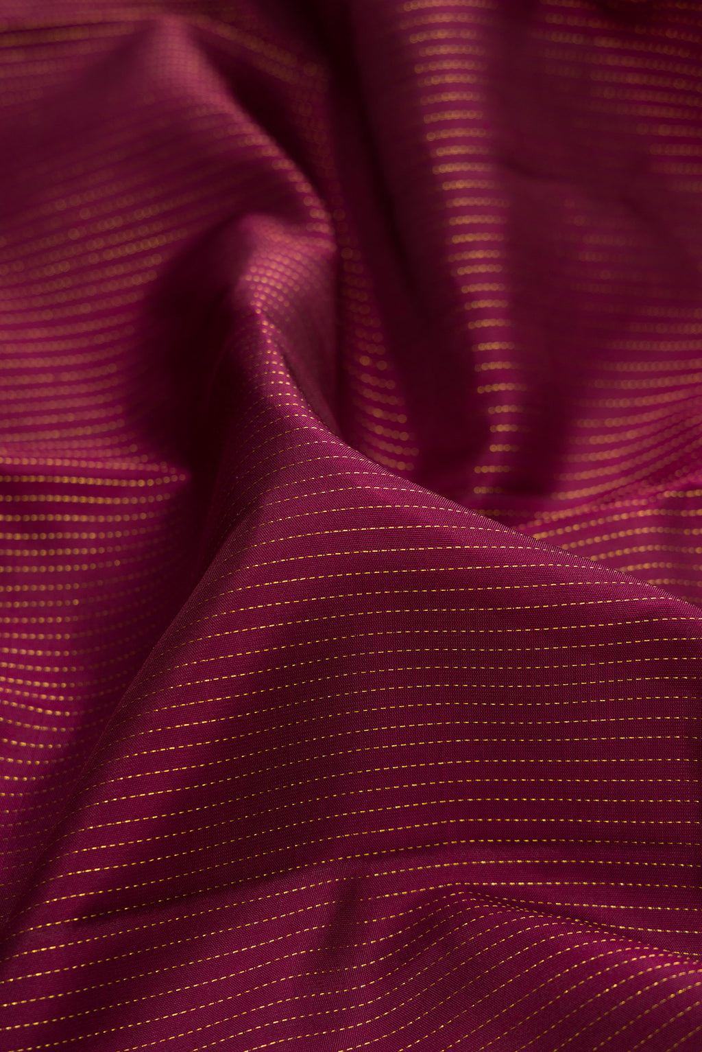 Close up of Pure Silk Maroon Kanchipuram Saree with Stripes on the body and Fancy Border.  displaying folds