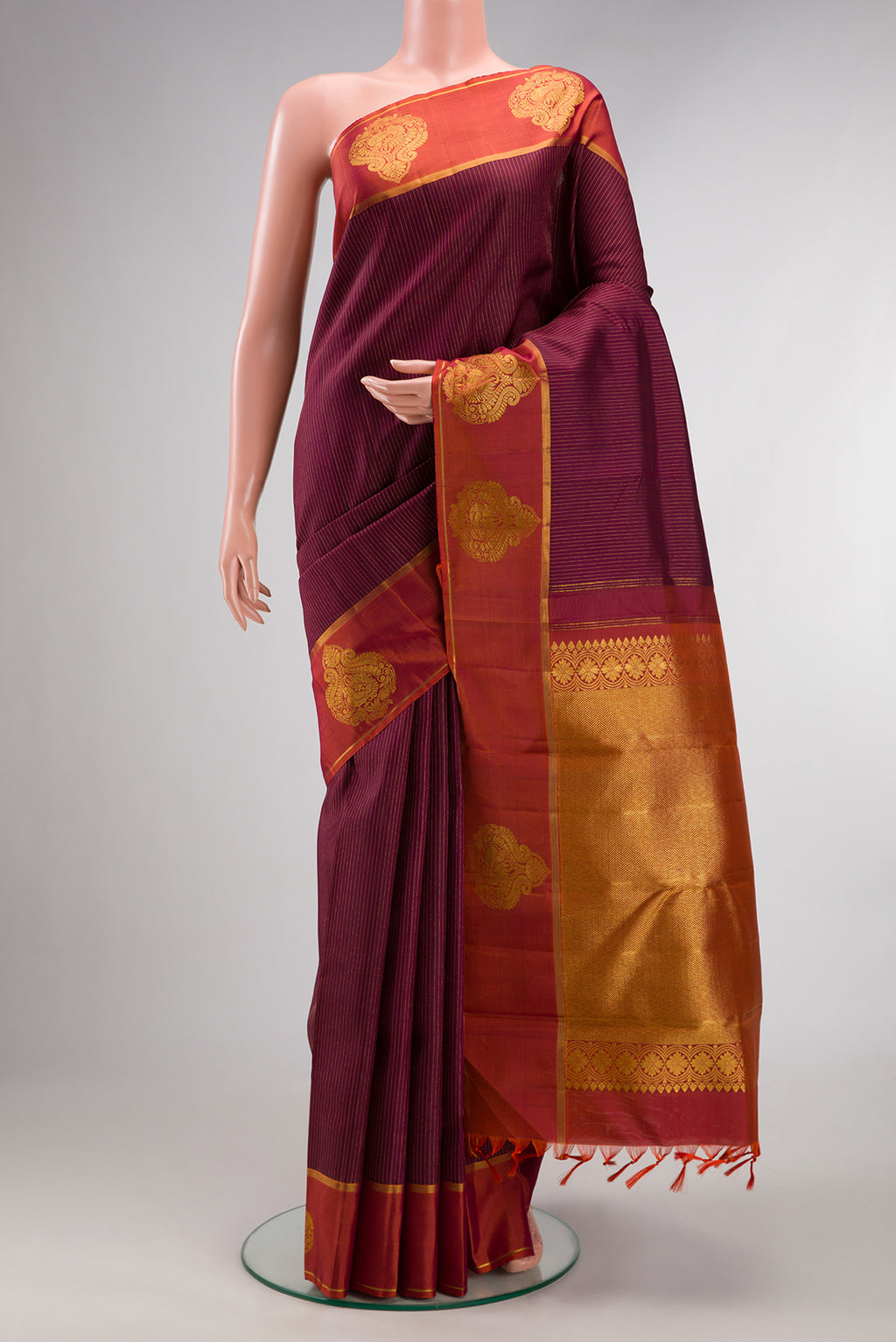 Pure Silk Maroon Kanchipuram Saree with Stripes on the body and Fancy Border.  displayed on a mannequin