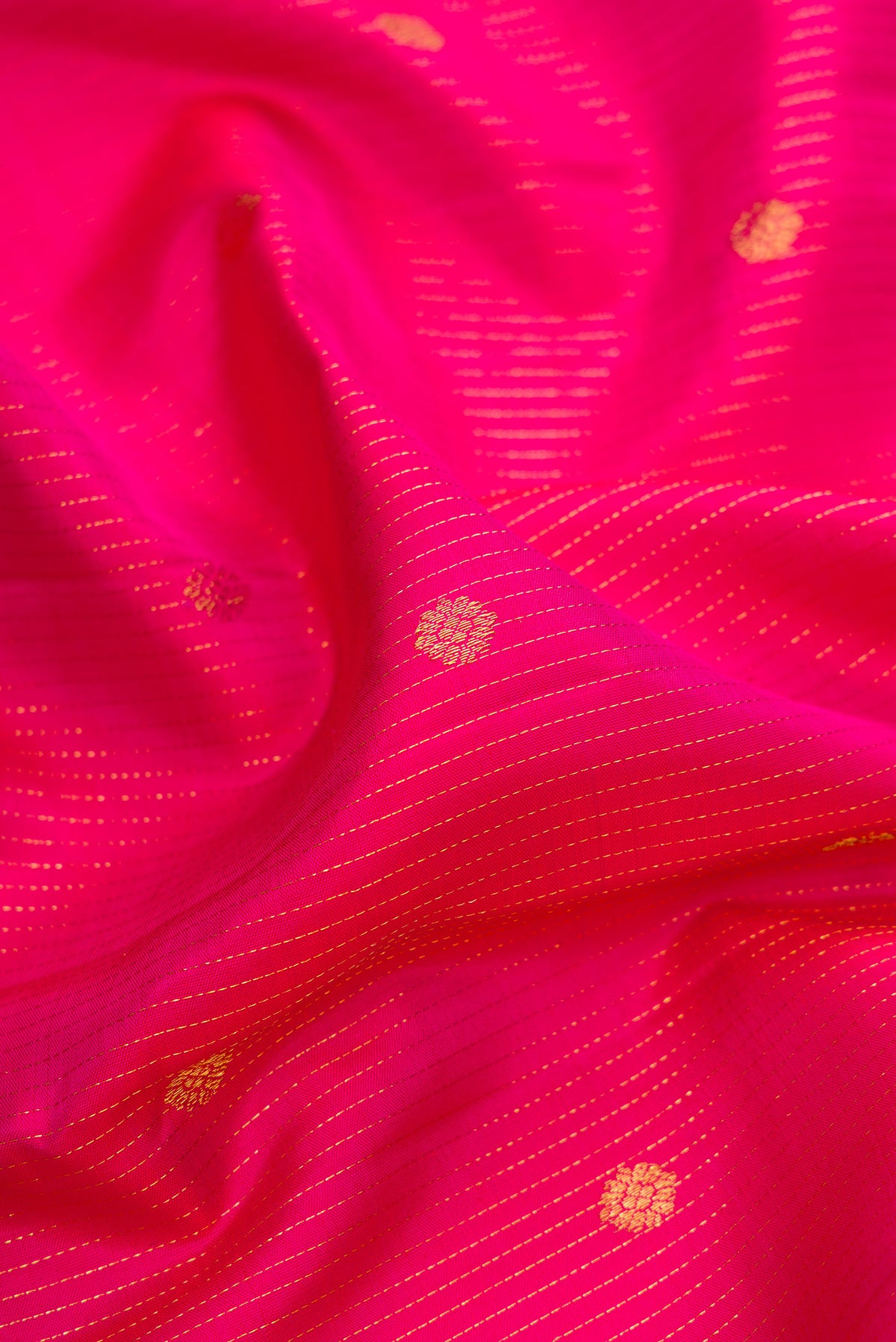 Close up of Pure Silk Pink Kanjivaram Saree with Stripes on the body and Zari Border.  displaying folds