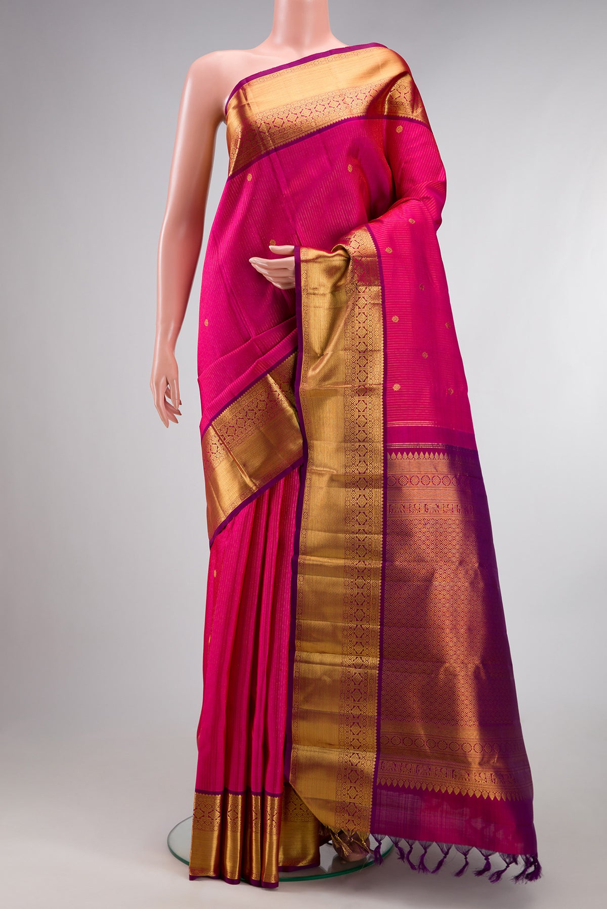 Pure Silk Pink Kanjivaram Saree with Stripes on the body and Zari Border.  displayed on a mannequin
