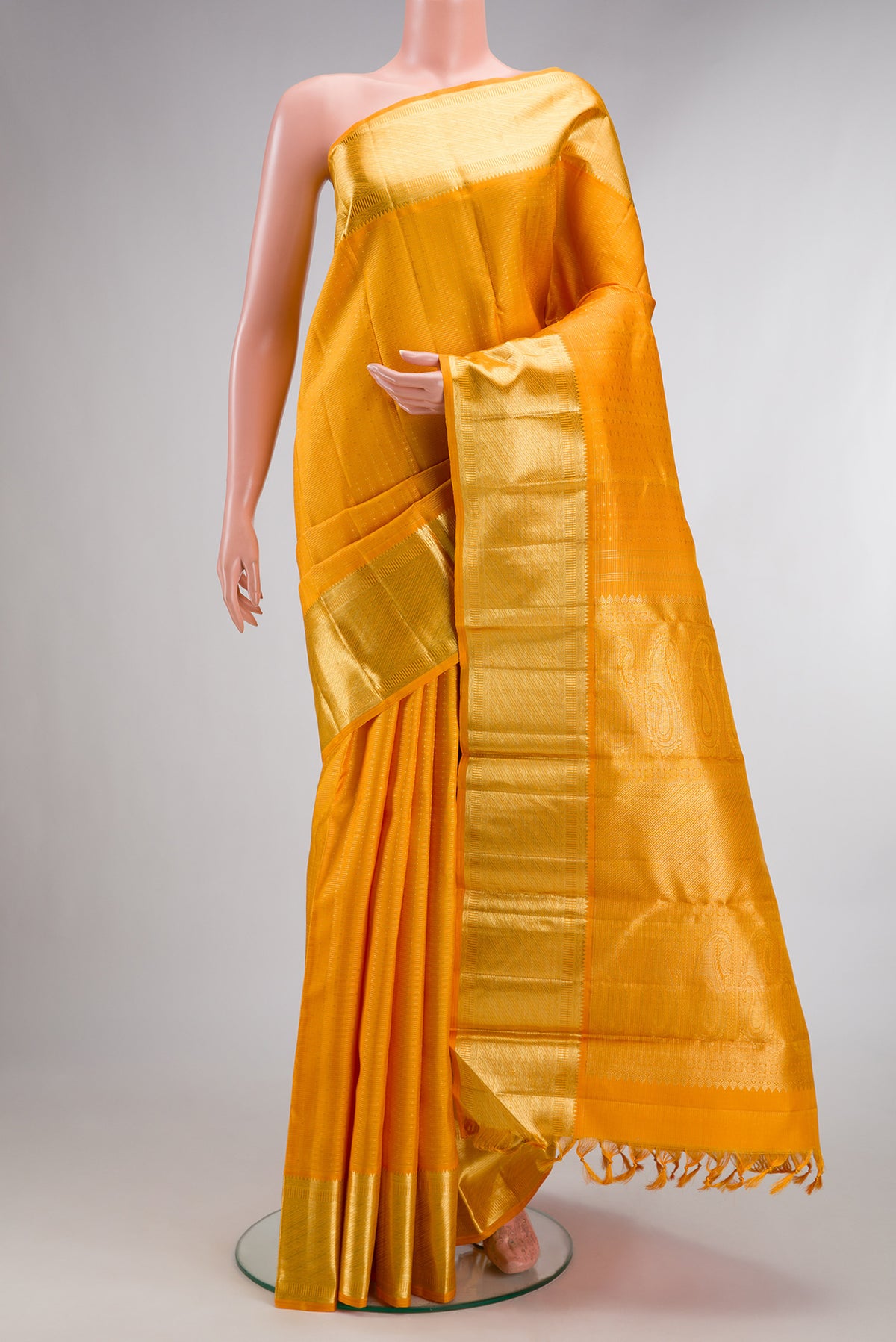 Pure Silk Mustard Kanjivaram Saree with Stripes on the body and Zari Border.  displayed on a mannequin