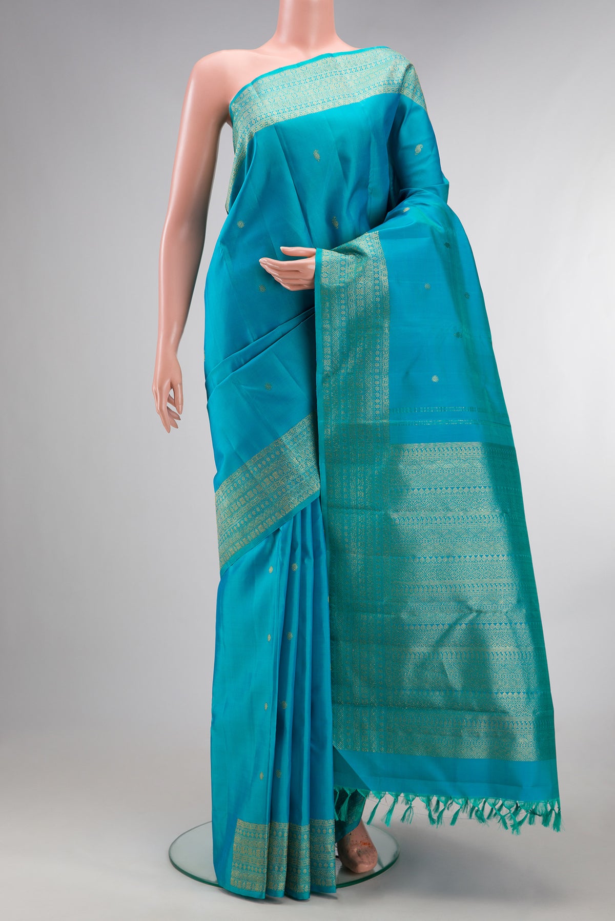 Pure Silk Sky Blue Kanjivaram Saree with Zari Butta on the body and Fancy Border.  displayed on a mannequin