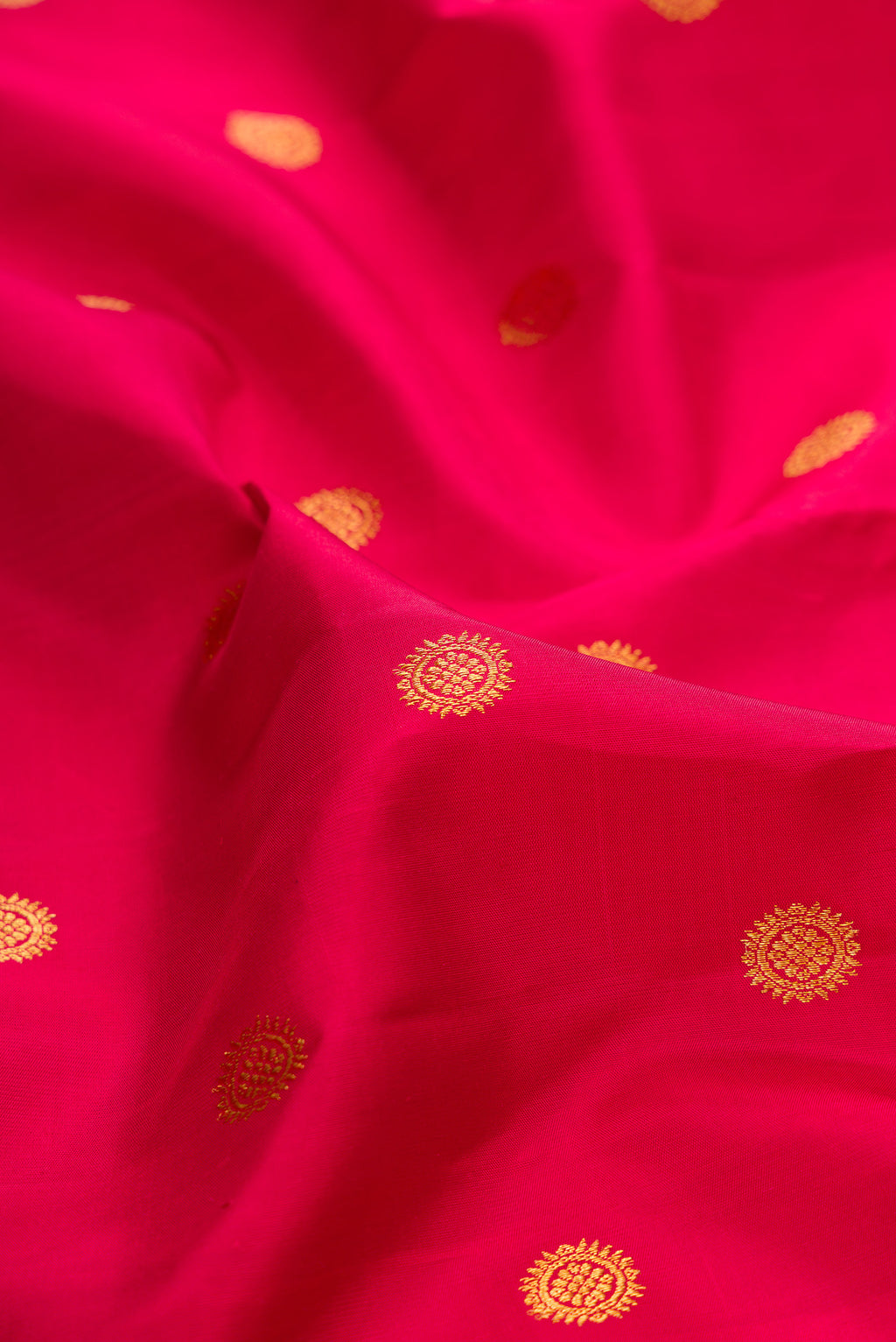 Close up of Pure Silk Deep Red Kanjivaram Saree with Zari Butta on the body and Fancy Border.  displaying folds