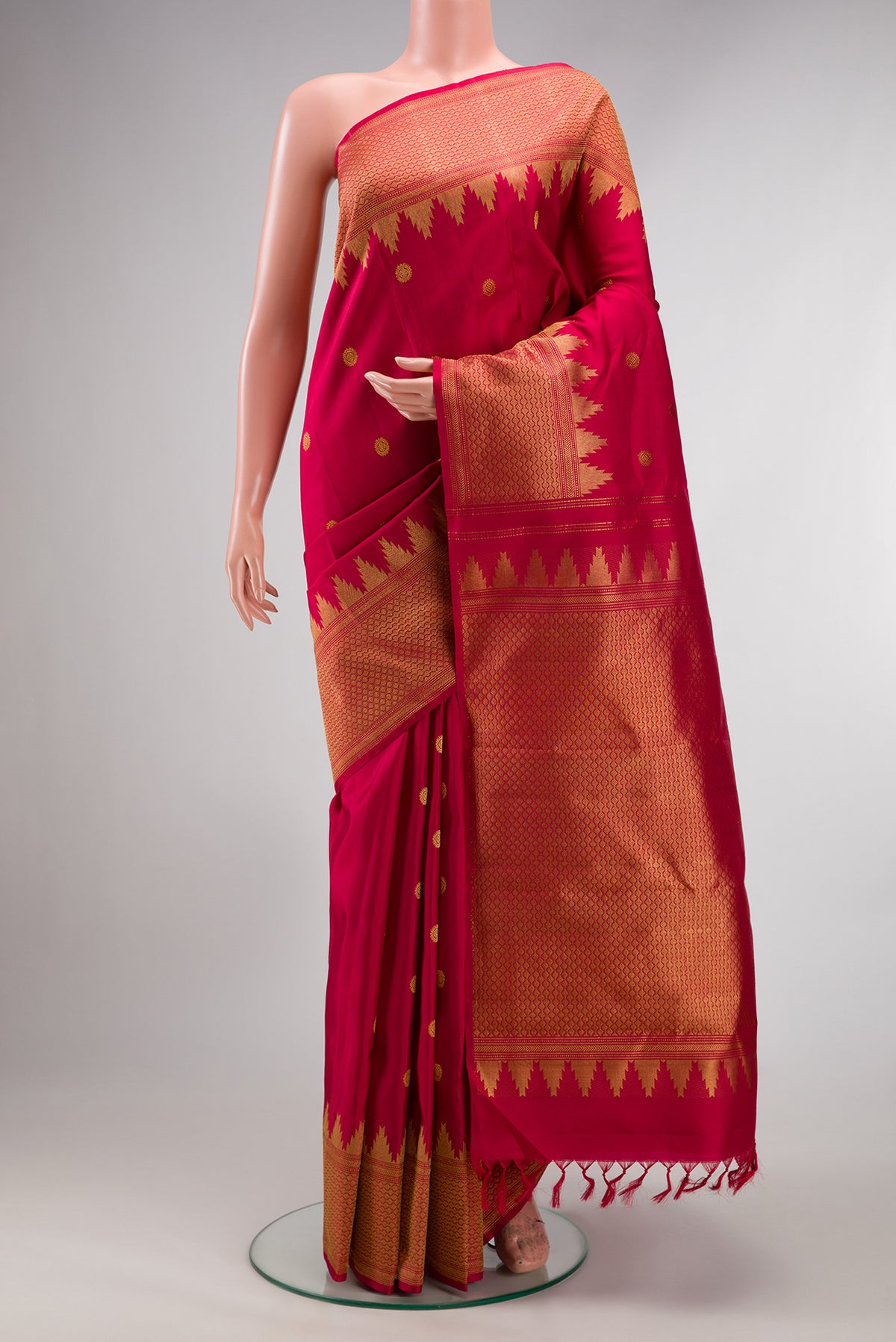 Pure Silk Deep Red Kanjivaram Saree with Zari Butta on the body and Fancy Border.  displayed on a mannequin