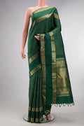 Pure Silk Green Kanjivaram Saree with Zari Butta on the body and Zari Border.  displayed on a mannequin