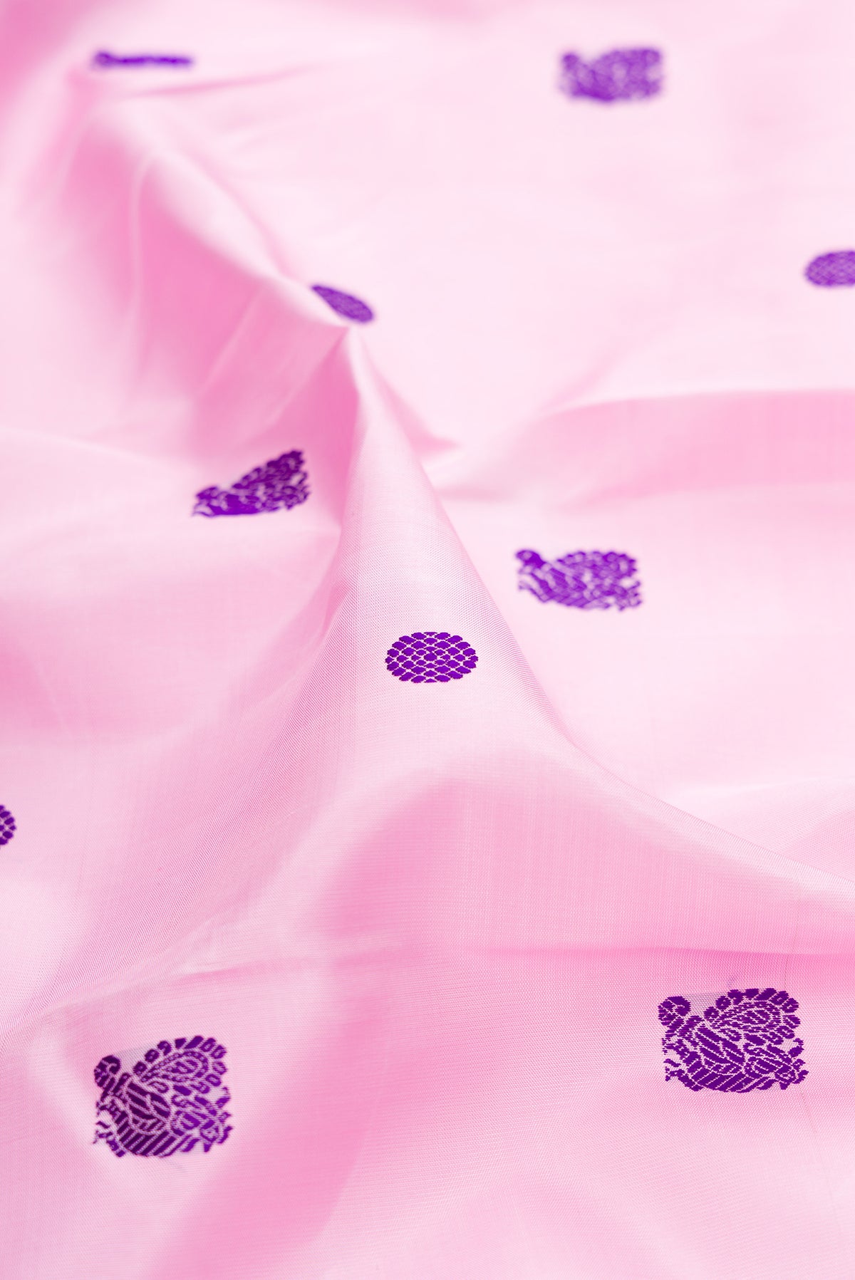 Close up of Pure Silk Pure Zari Pink Dual Tone Kanjivaram Saree with Thread Butta on the body and Zari Border.  displaying folds
