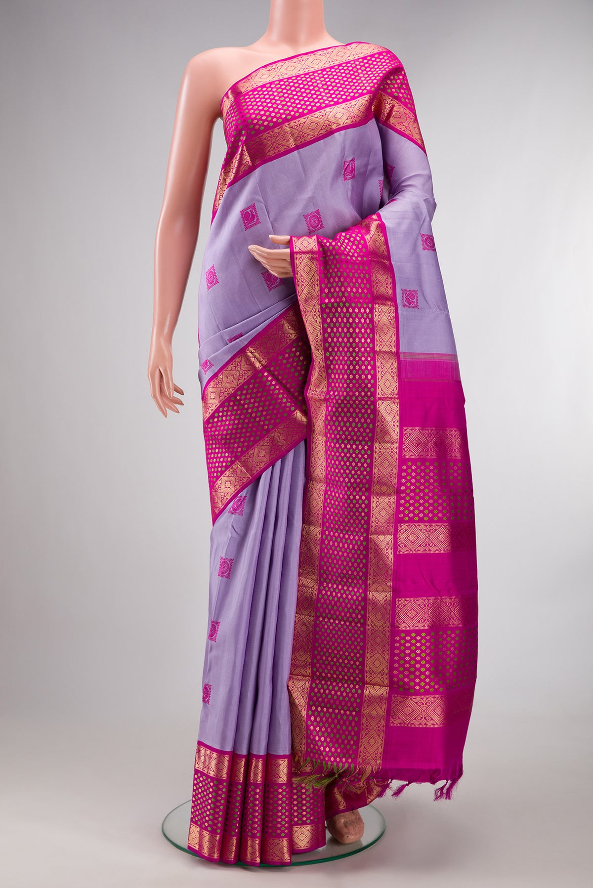 Pure Silk Lavender Kanjivaram Saree with Thread Butta on the body and Zari Border.  displayed on a mannequin