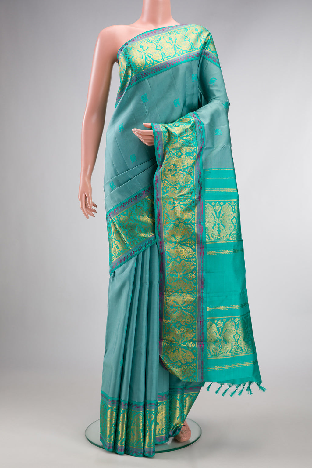Pure Silk Turquoise Dual Tone Kanjivaram Saree with Thread Butta on the body and Fancy Border.  displayed on a mannequin