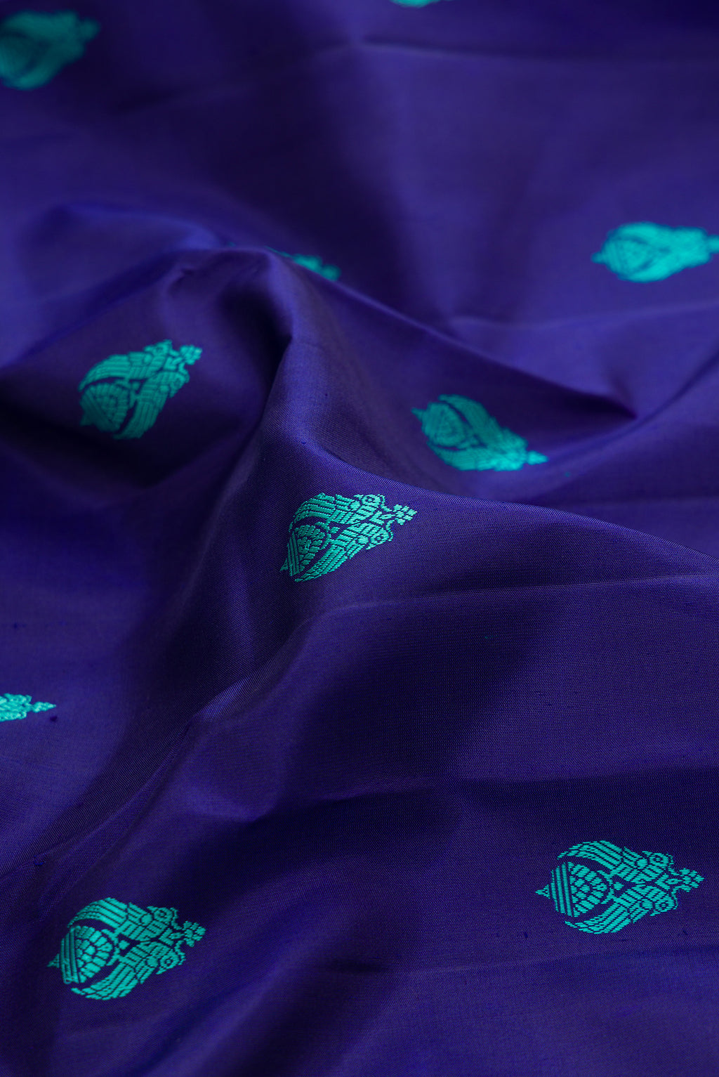 Close up of Pure Silk Pure Zari Royal Blue Dual Tone Kanjivaram Saree with Thread Butta on the body and Zari Border.  displaying folds