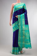 Pure Silk Pure Zari Royal Blue Dual Tone Kanjivaram Saree with Thread Butta on the body and Zari Border.  displayed on a mannequin