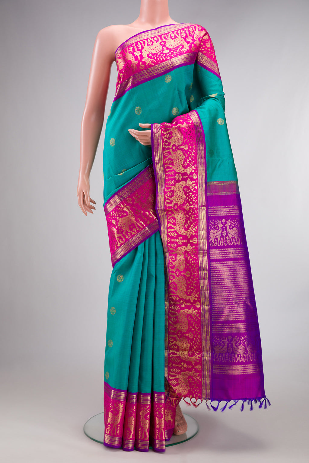 Pure Silk Sea Green Dual Tone Kanjivaram Saree with Zari Butta on the body and Fancy Border.  displayed on a mannequin