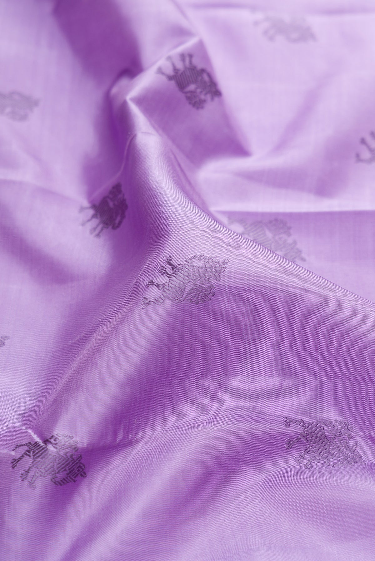 Close up of Pure Silk Pure Zari Lavender Dual Tone Kanjivaram Saree with Thread Butta on the body and Zari Border.  displaying folds
