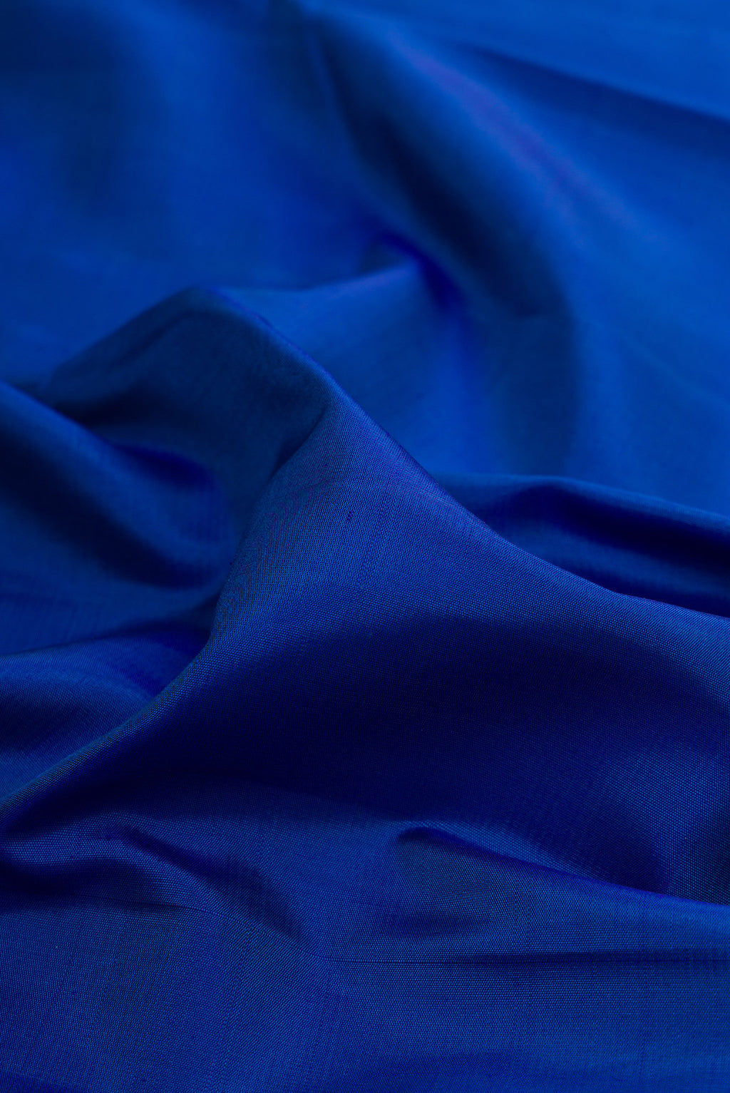 Close up of Pure Silk Royal Blue Kanchipuram Saree with Plain Body and Fancy Border.  displaying folds