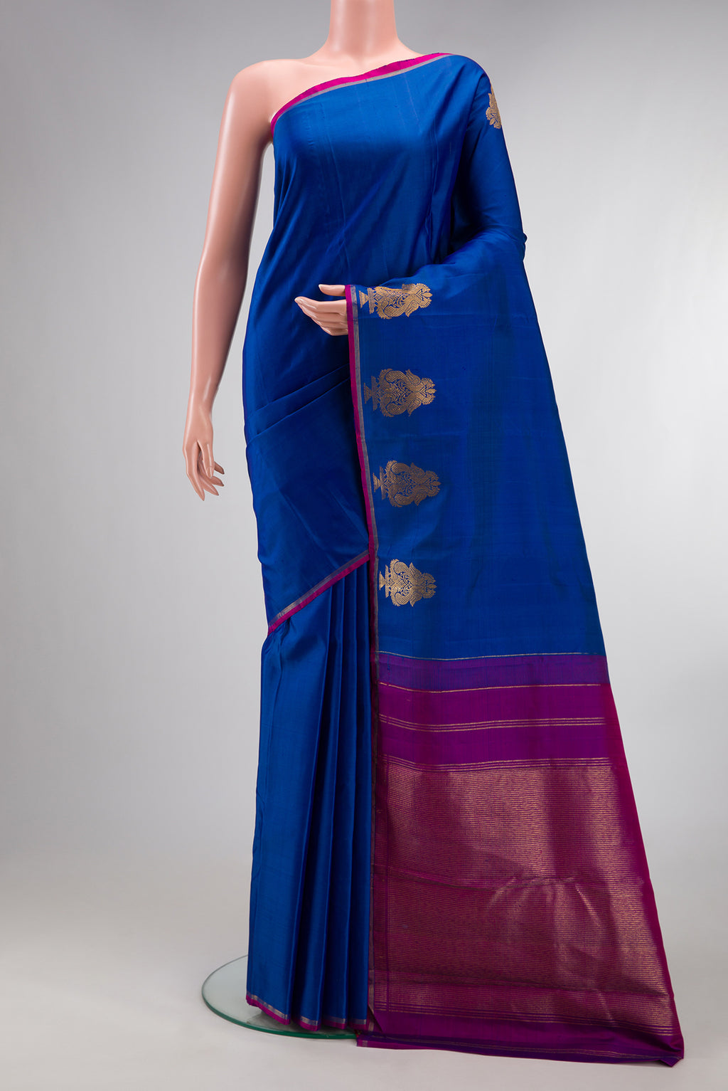 Pure Silk Royal Blue Kanchipuram Saree with Plain Body and Fancy Border.  displayed on a mannequin