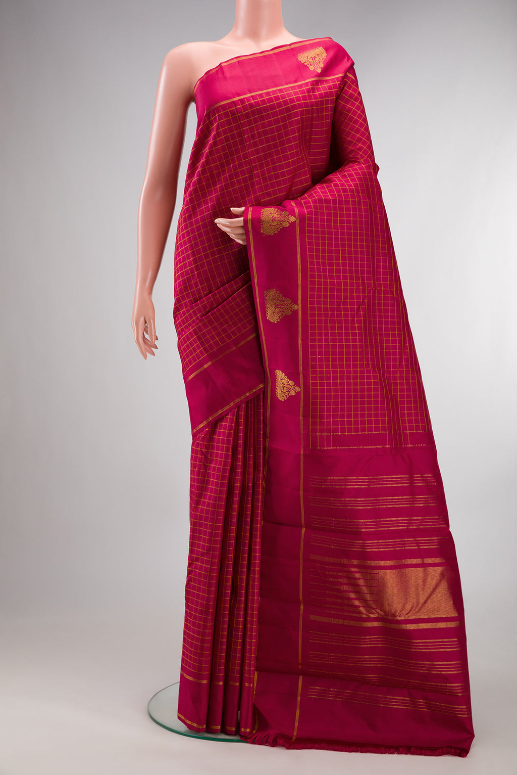 Pure Silk Maroon Kanchipuram Saree with Checked design on the body and Fancy Border.  displayed on a mannequin