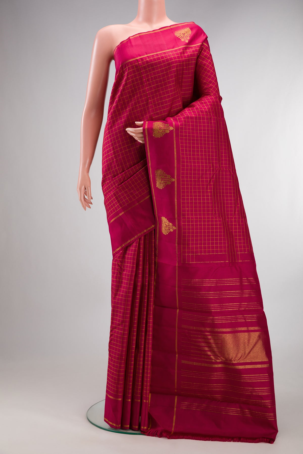 Pure Silk Maroon Kanchipuram Saree with Checked design on the body and Fancy Border.  displayed on a mannequin